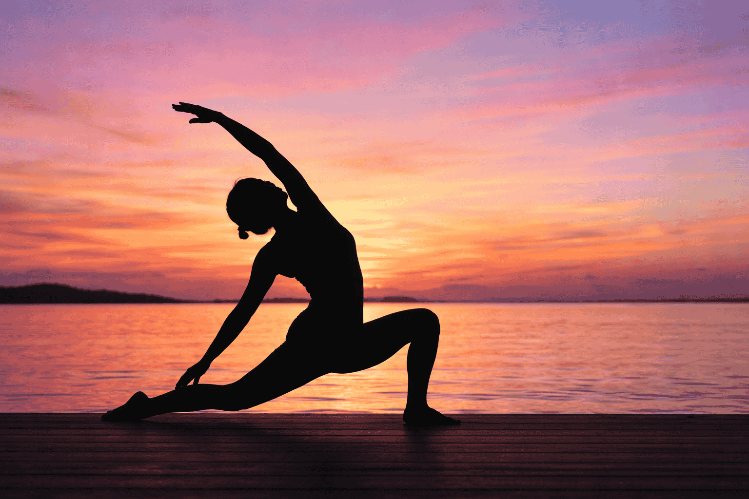 Person practicing gentle stretching exercises on a yoga mat, demonstrating Makko-Ho meridian stretching